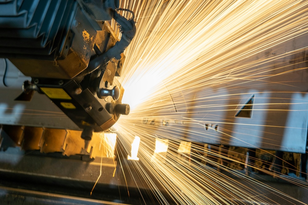 A machine during manufacturing with sparks flying off the chosen material.