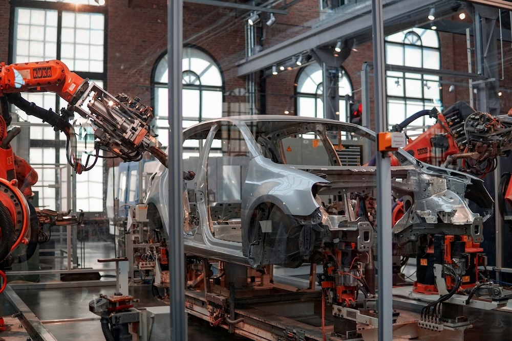 A car part-way through manufacturing using automated machines.